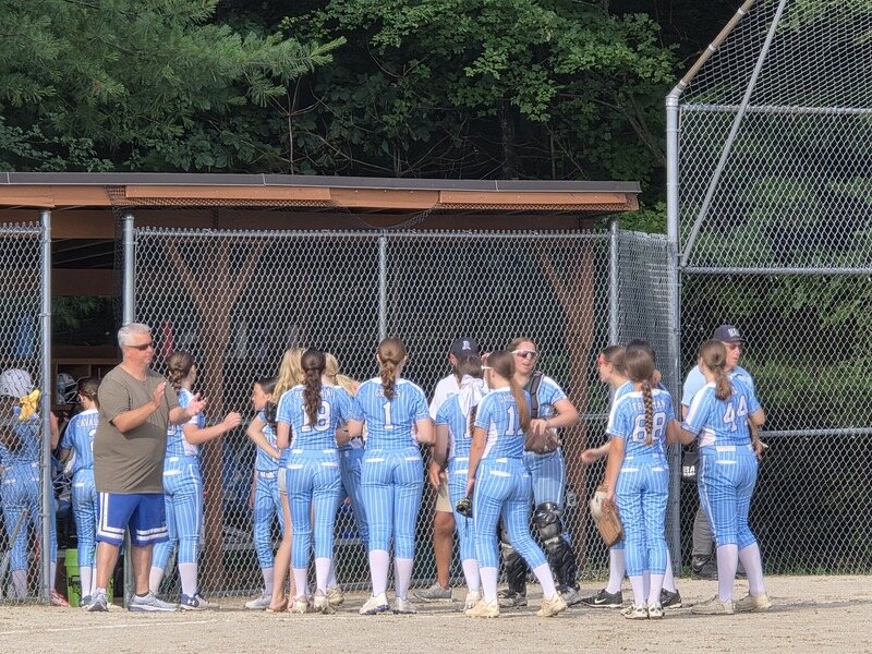 Metrowest Devils players near the dugout